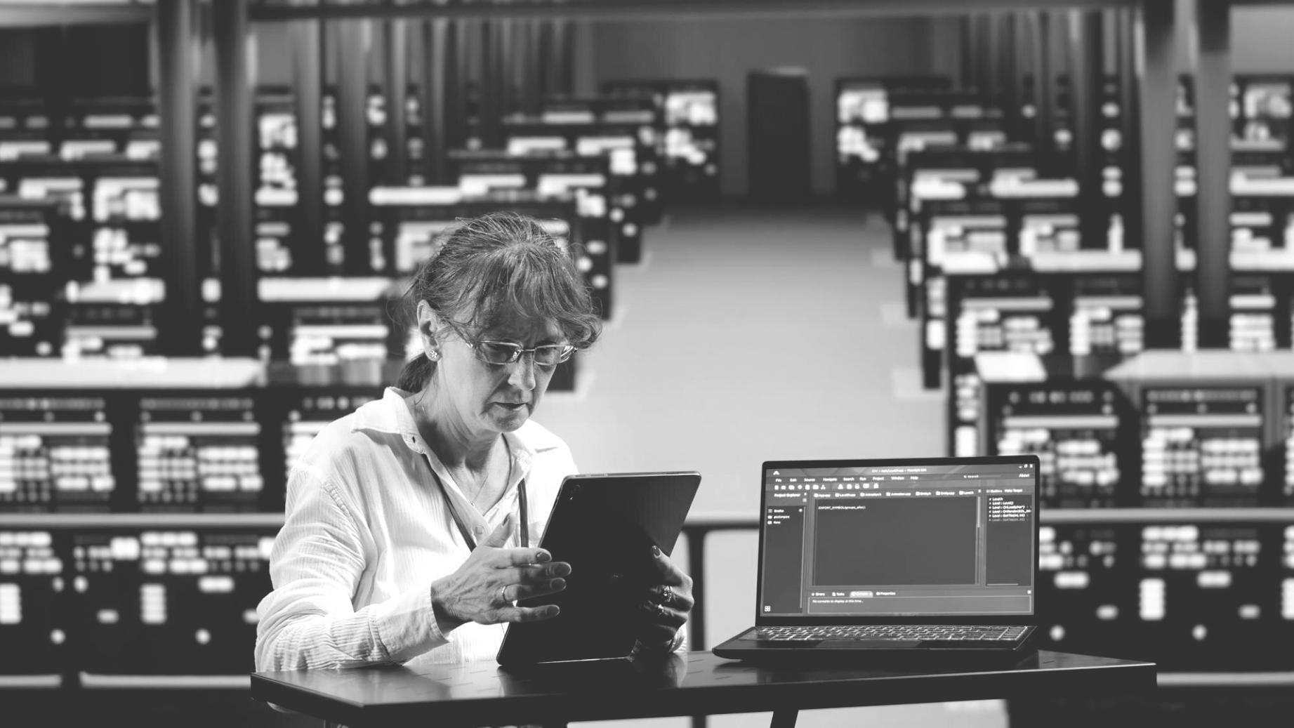 Designer analyzing user flow patterns on multiple device screens